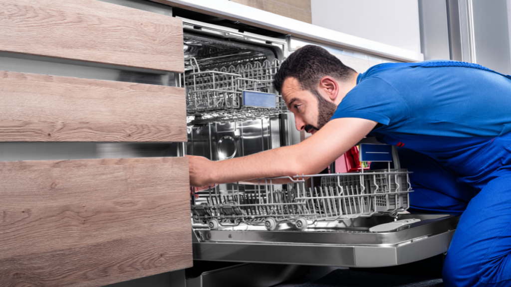 Man inspecting a dishwasher