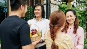 Adult Children Handing Gifts to Their Parents