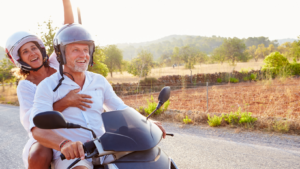 An older couple on a motor scooter