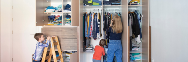 A mom and kids organizing a closet