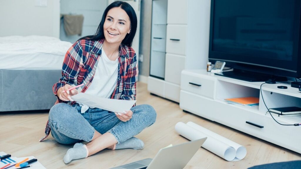 Woman surrounded by paperwork at home