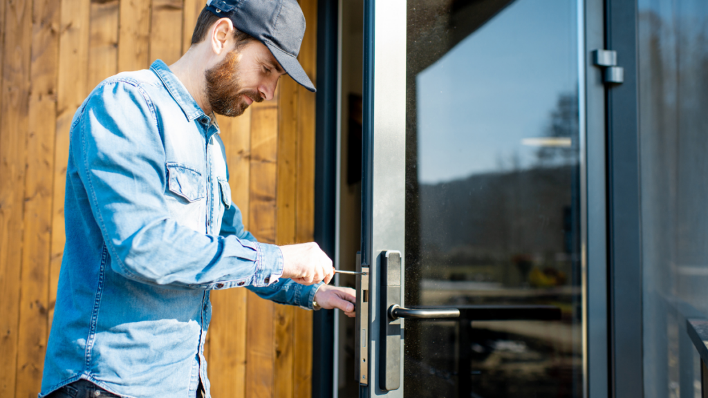 A man working on the door handle with a screw driver